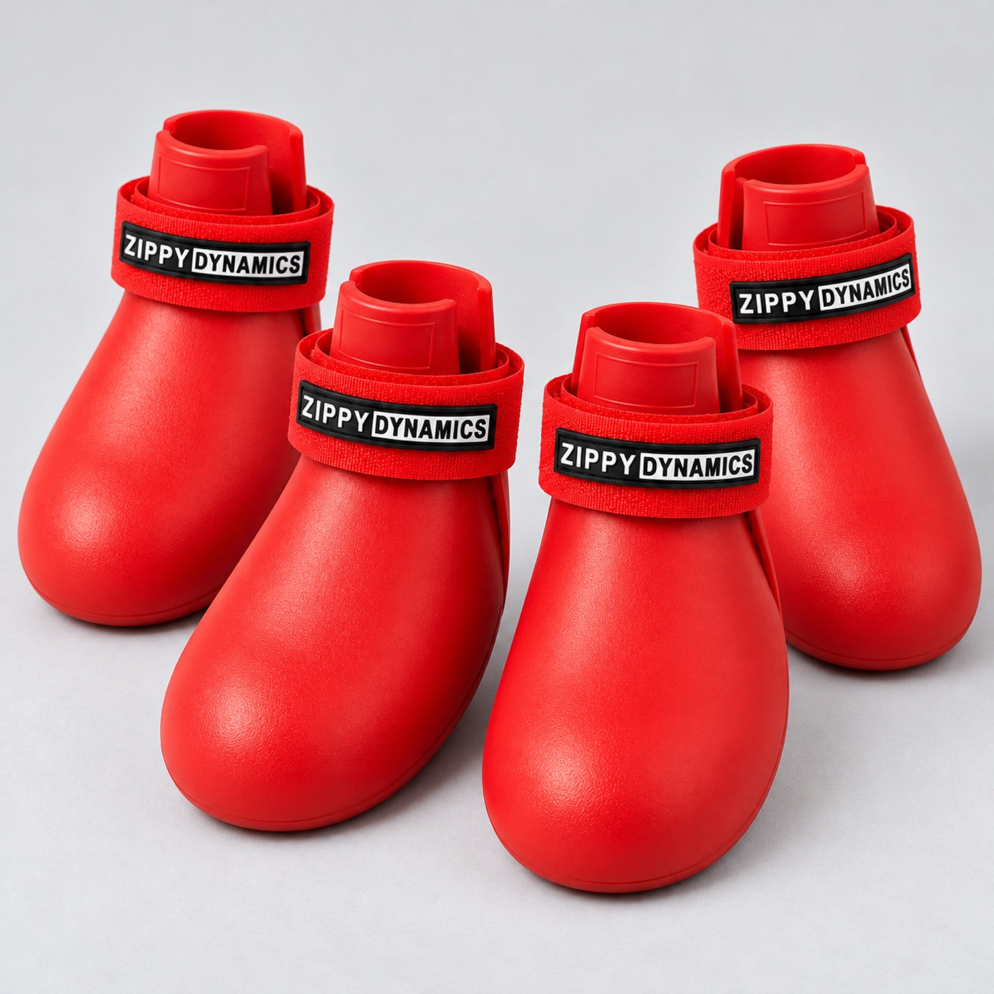 Four red ZippyPaws dog boots
